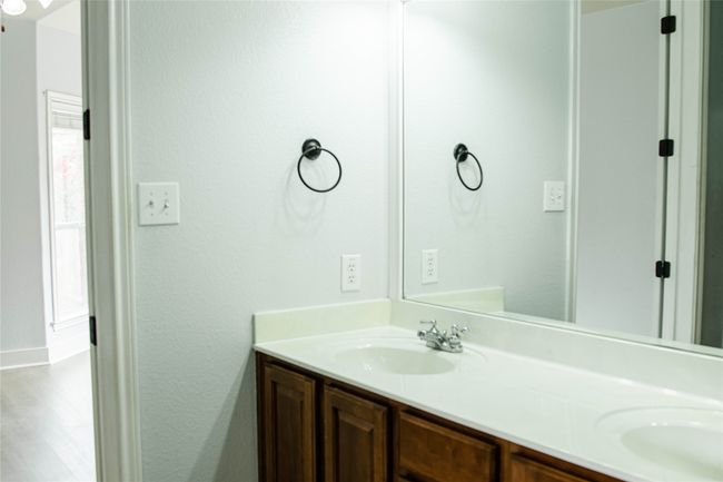 Bathroom featuring double vanity and baseboards | Image 21
