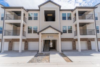 View of property featuring a balcony and a garage | Image 1