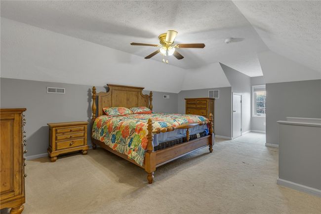 This is the very spacious upper bedroom. This could easily be used as a master bedroom as it has its own full bath and walk in closet as well. Also makes a fabulous suite for guests. | Image 15