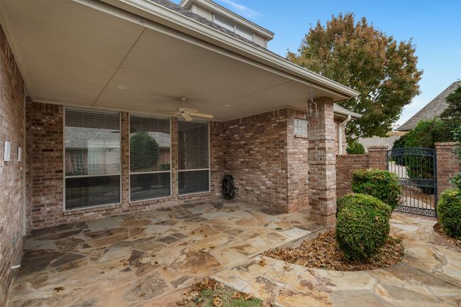 View of patio featuring ceiling fan and a gate | Image 34