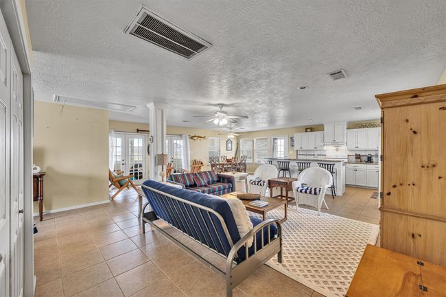 A view across the family room toward the dining, sitting area and kitchen. | Image 10