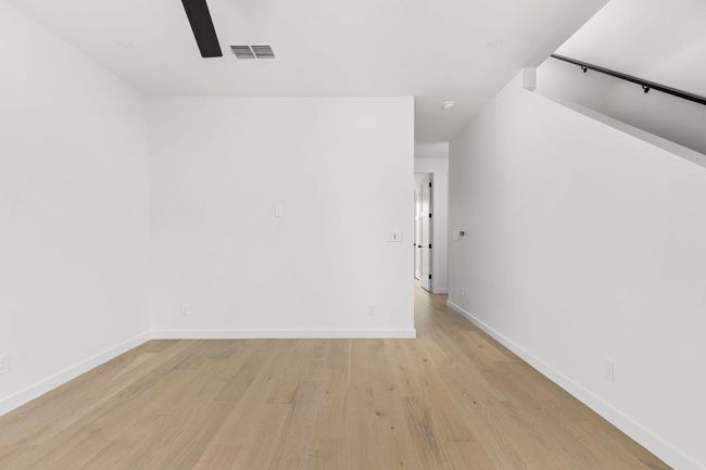 Spare room with a ceiling fan and light wood-style flooring | Image 29