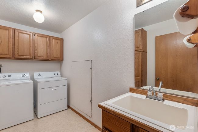 Spacious laundry room with utility sink. Washer and dryer are included! | Image 31