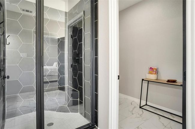 Bathroom with tile flooring and a shower with shower door | Image 27