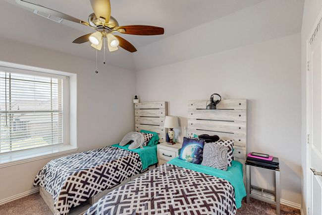 Carpeted bedroom featuring baseboards, visible vents, and a ceiling fan | Image 17