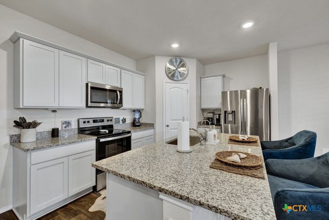 Kitchen view with a walk in corner pantry | Image 5