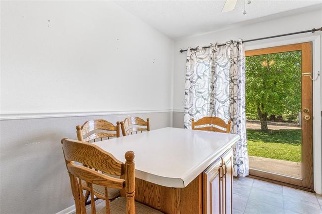Dining space featuring light tile patterned floors | Image 38