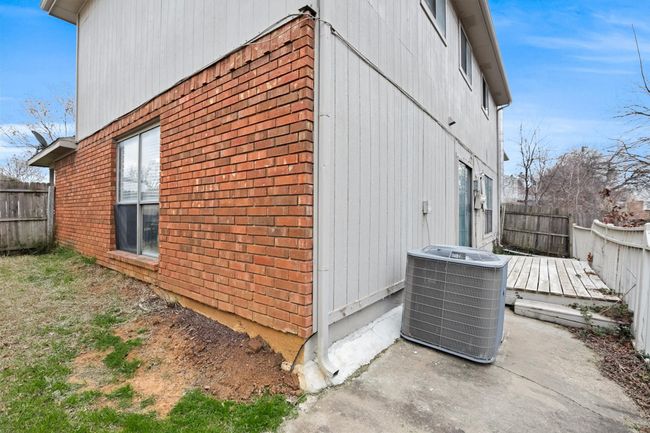 View of property exterior with brick siding and a deck | Image 31