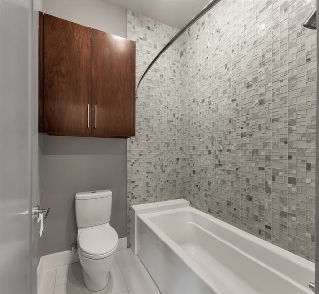 Full bathroom featuring a bathtub, tile patterned floors, a shower, and tile walls | Image 25