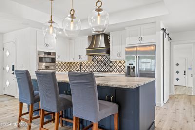 Upscale finishes are found throughout. Breakfast bar with granite counters | Image 3