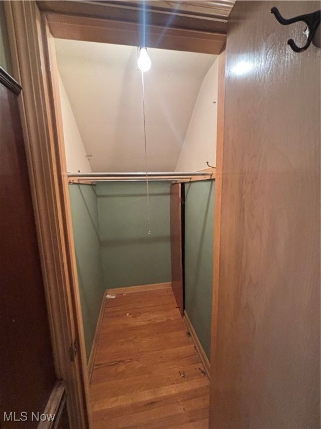 Walk in closet featuring wood finished floors | Image 12
