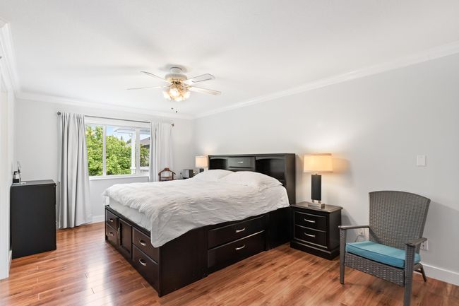 Bedroom featuring ornamental molding, light wood finished floors, baseboards, and ceiling fan | Image 14