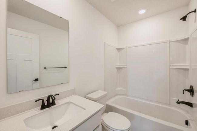 (*Photo of actual home) The upper level secondary full bathroom | Image 15