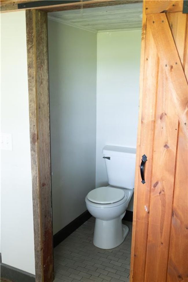 Bathroom with toilet and tile patterned floors | Image 4