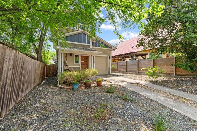 Mid-century modern home featuring concrete driveway, fence, and a garage | Image 27