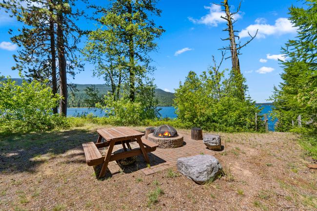 View of yard with an outdoor fire pit and a water and mountain view | Image 23