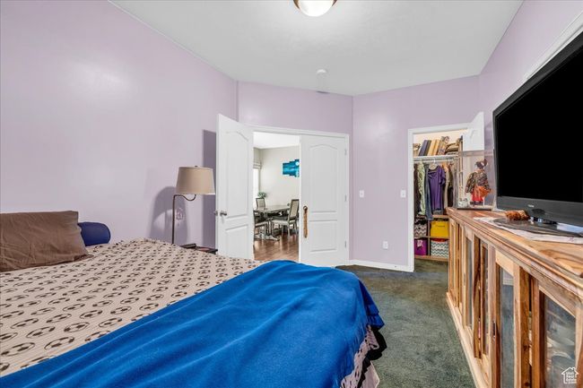 Bedroom with a spacious closet, a closet, carpet flooring, and baseboards | Image 24