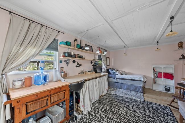 Bedroom with wood finished floors, wood ceiling, and crown molding | Image 31