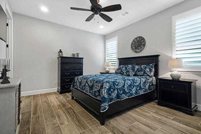 Bedroom featuring wood finish floors, ceiling fan, baseboards, and recessed lighting | Image 20