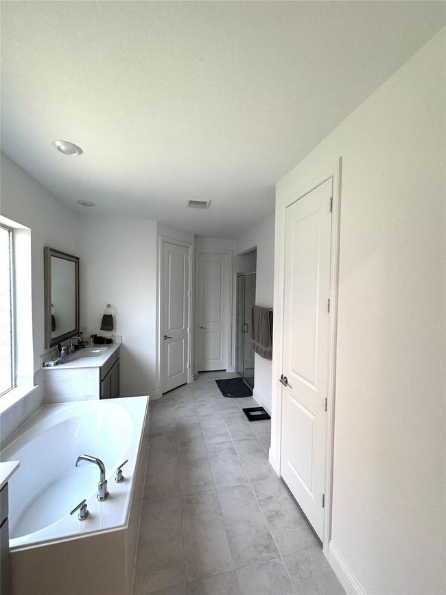 Bathroom with vanity, a bath, and a shower stall | Image 7