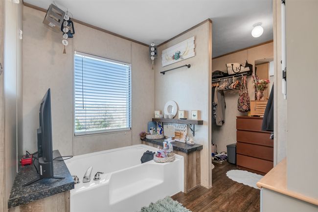 Full bathroom featuring a bath and wood finished floors | Image 26