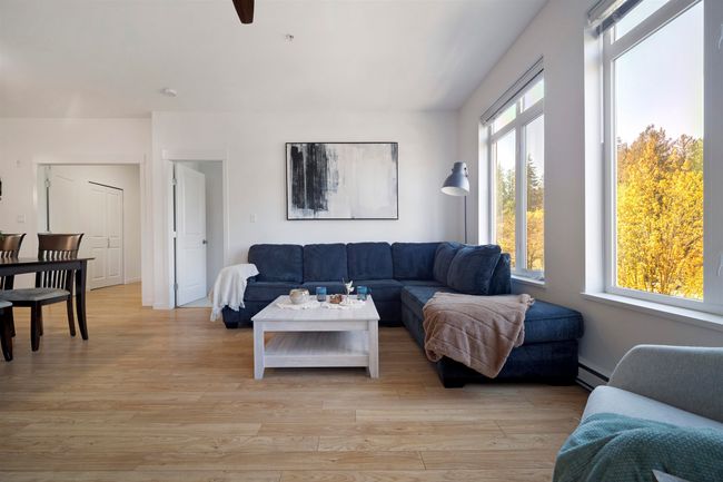 Living room featuring light wood finished floors and a baseboard radiator | Image 12