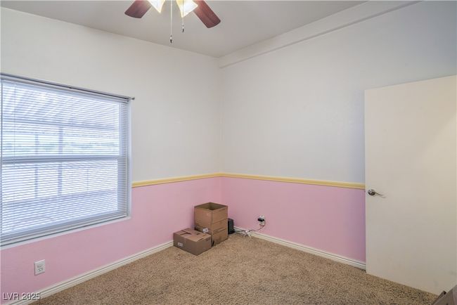 Empty room with carpet floors, ceiling fan, and baseboards | Image 25