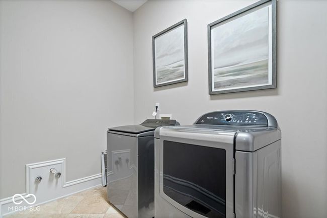 Main level laundry room. This home features 3 separate laundry areas (one in the primary closet and the other on the 2nd level). | Image 43