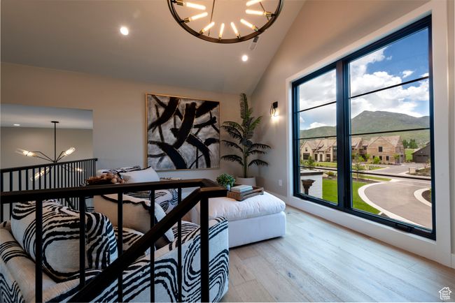 Living area with a chandelier, wood finished floors, a mountain view, recessed lighting, and high vaulted ceiling | Image 40