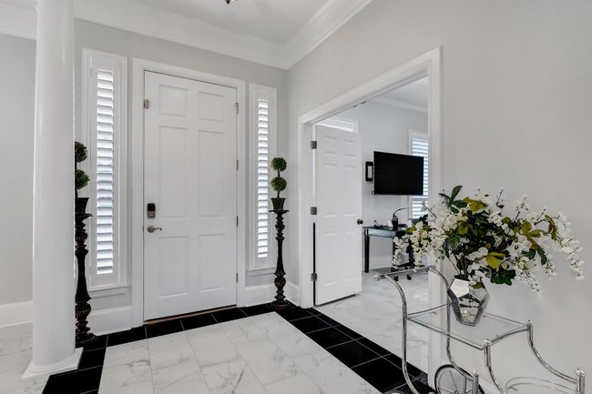 Entryway with crown molding and marble finish flooring | Image 4