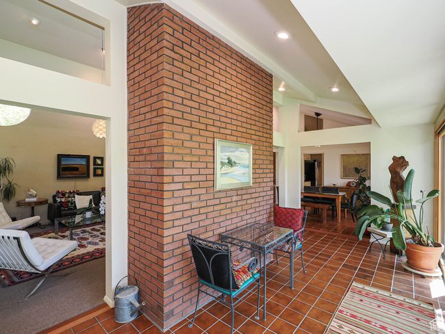 Hall featuring tile patterned flooring, brick wall, and recessed lighting | Image 19