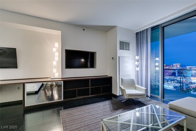 Living room featuring a wall of windows and wood finished floors | Image 14