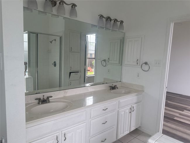 Full bath with a shower stall, tile patterned floors, a sink, and double vanity | Image 12