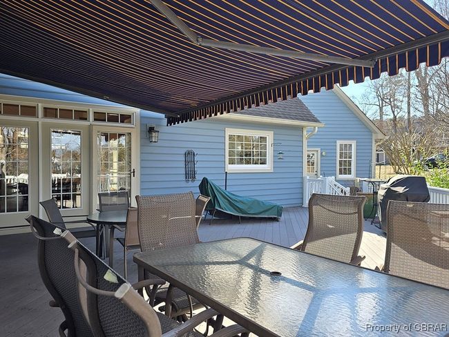 View of patio with a deck and outdoor dining area | Image 10