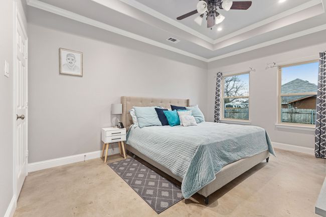 Bedroom featuring a raised ceiling, crown molding, and ceiling fan | Image 16