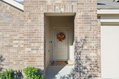 Doorway to property with a garage | Image 2