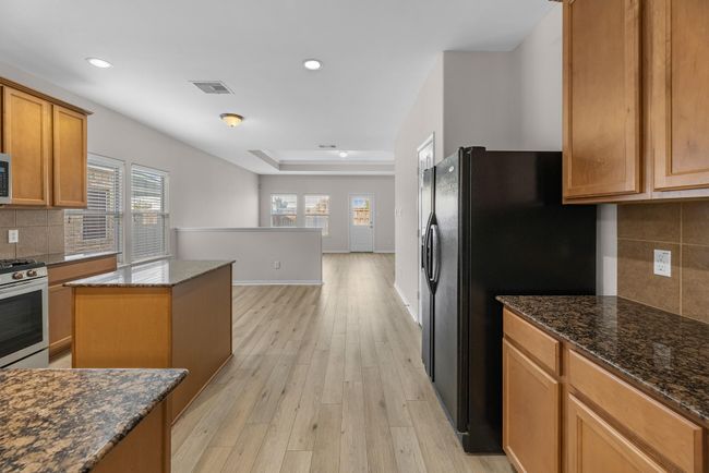 This kitchen is not only a functional space but also has ample storage. Whether you're a seasoned chef or just love to gather and enjoy good food, this kitchen is a dream come true. | Image 8