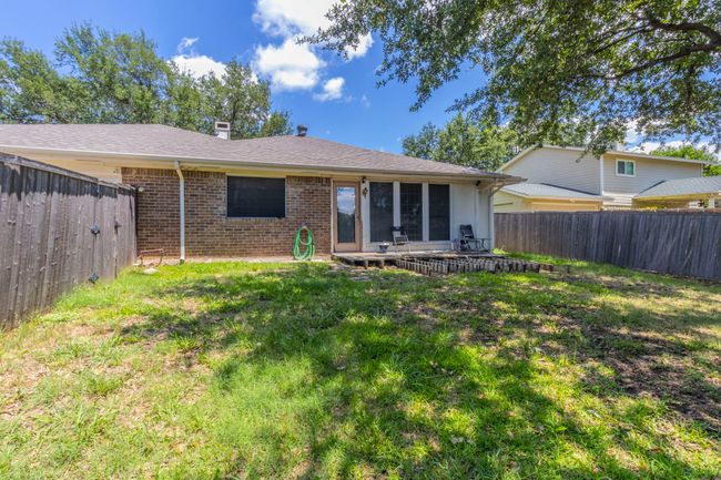 Back of property with brick siding, a patio area, and a chimney | Image 25
