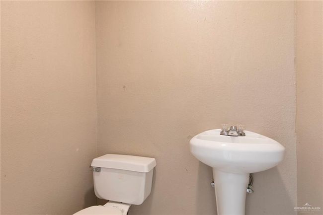 Half bathroom featuring toilet inside the garage. | Image 21