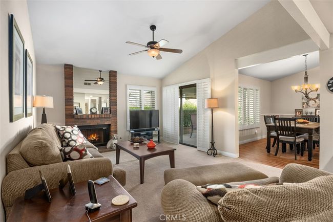 The living room is just off the dining room area. You also have access to your own patio area as well | Image 12