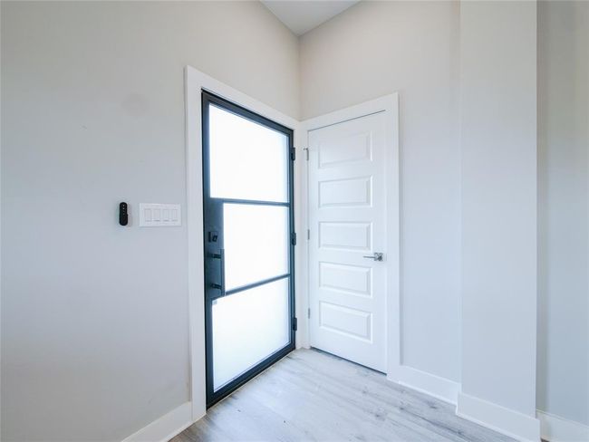Doorway featuring light wood-style flooring and baseboards | Image 6