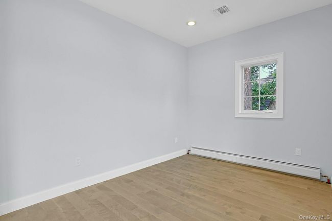 Dining room featuring light wood-style floors, baseboard heating, and recessed lighting | Image 7