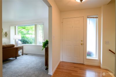 The entryway showcases beautiful hardwood floors and opens to the living room. Fresh paint throughout the interior of the home! | Image 2