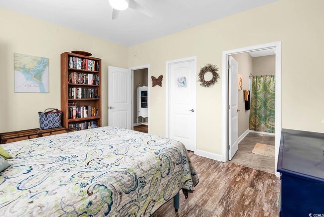 Bedroom featuring visible vents, wood finished floors, and a ceiling fan | Image 25