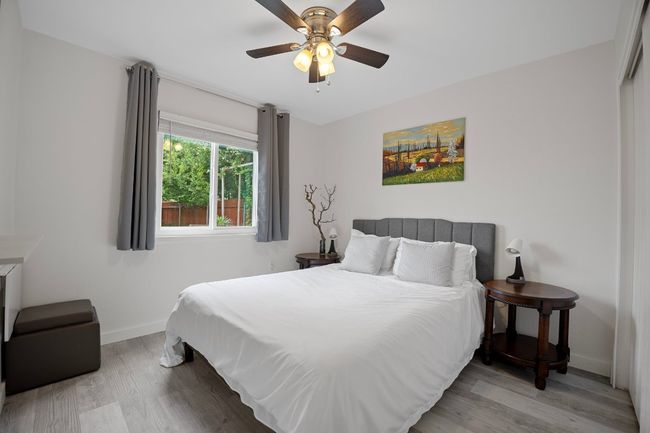 Bedroom with wood finished floors and ceiling fan | Image 16