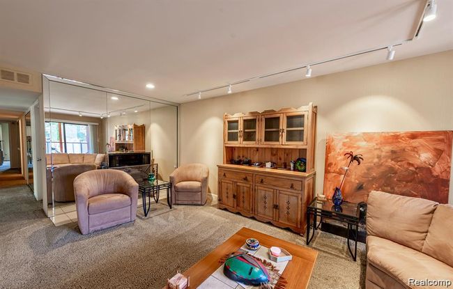 Living room with rail lighting and carpet floors | Image 9
