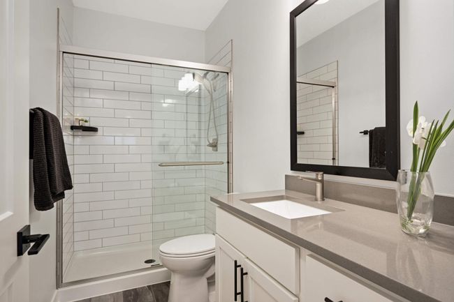 3/4 bathroom with quartz countertops and walk-in shower | Image 7