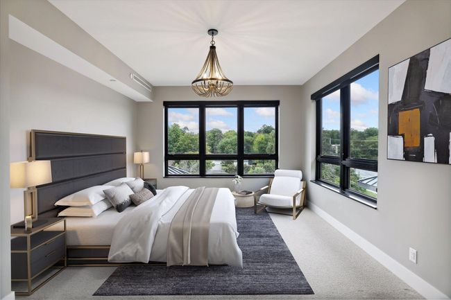 Spacious primary bedroom is filled with natural light | Image 9
