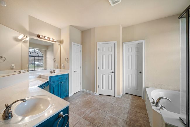 Full bathroom with tile patterned floors, a sink, a garden tub, visible vents, and double vanity | Image 20
