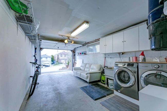 Laundry room with a garage, washer and dryer, and cabinet space | Image 28
